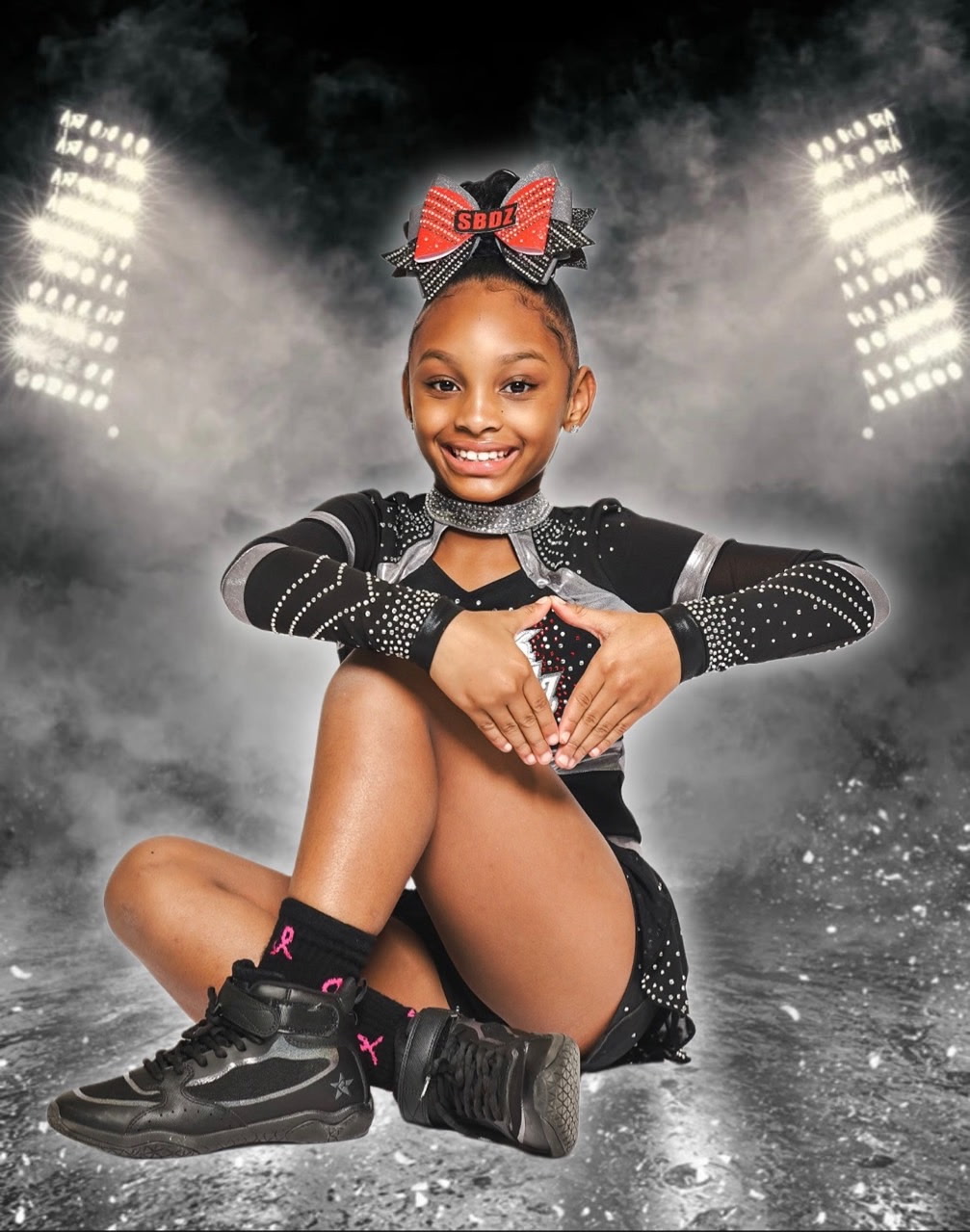 Black Diamonds cheerleader posed with heart hands